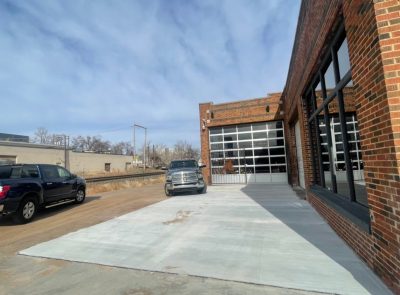 A brick structure with a spacious garage door, highlighting its functional design and sturdy construction.