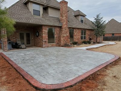 A brick patio featuring a matching brick walkway, creating a cohesive outdoor space.