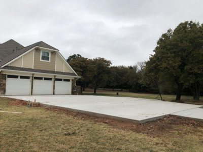 A house featuring a concrete foundation and an attached garage.